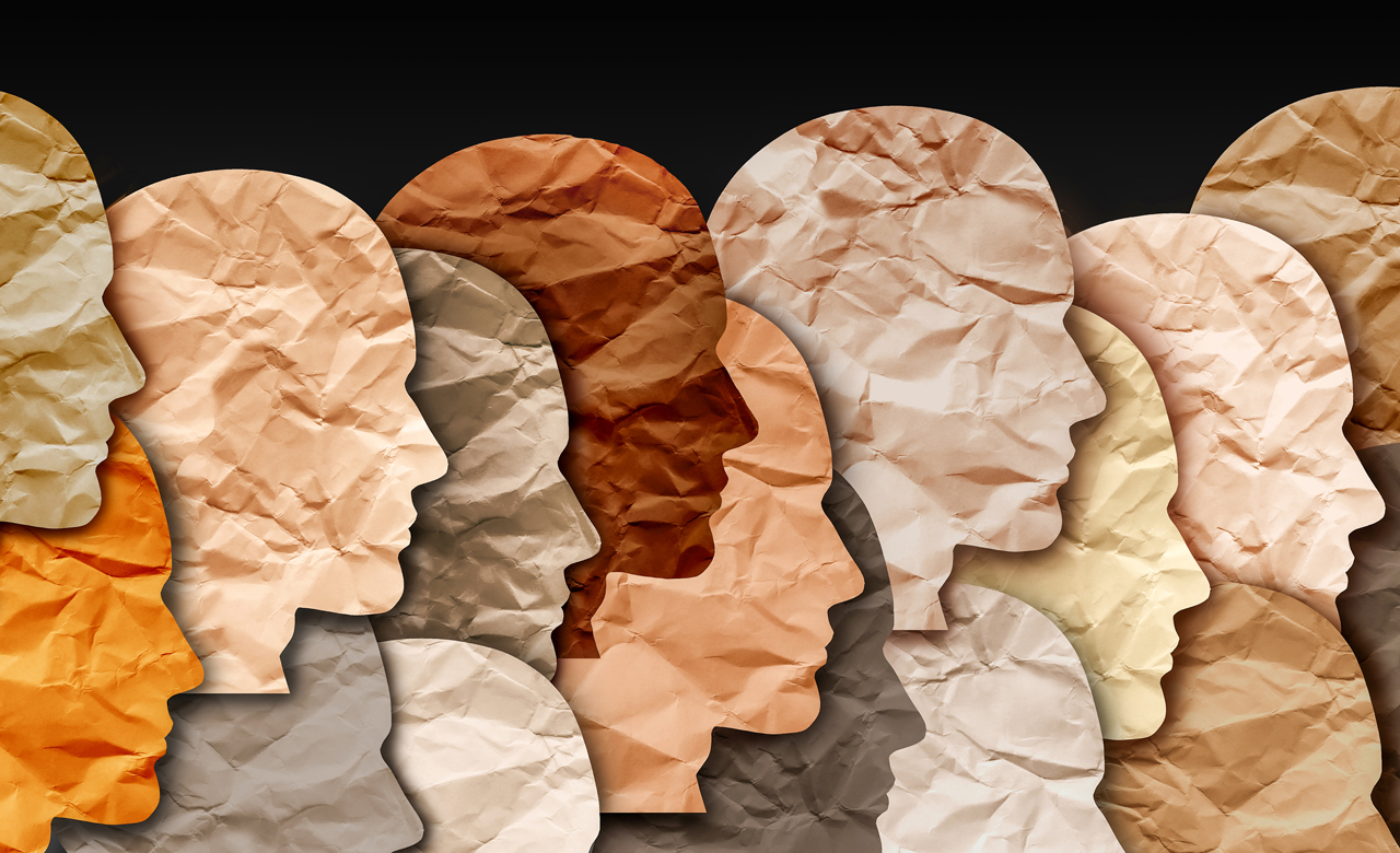 Human heads of various colors and races in a paper collage.