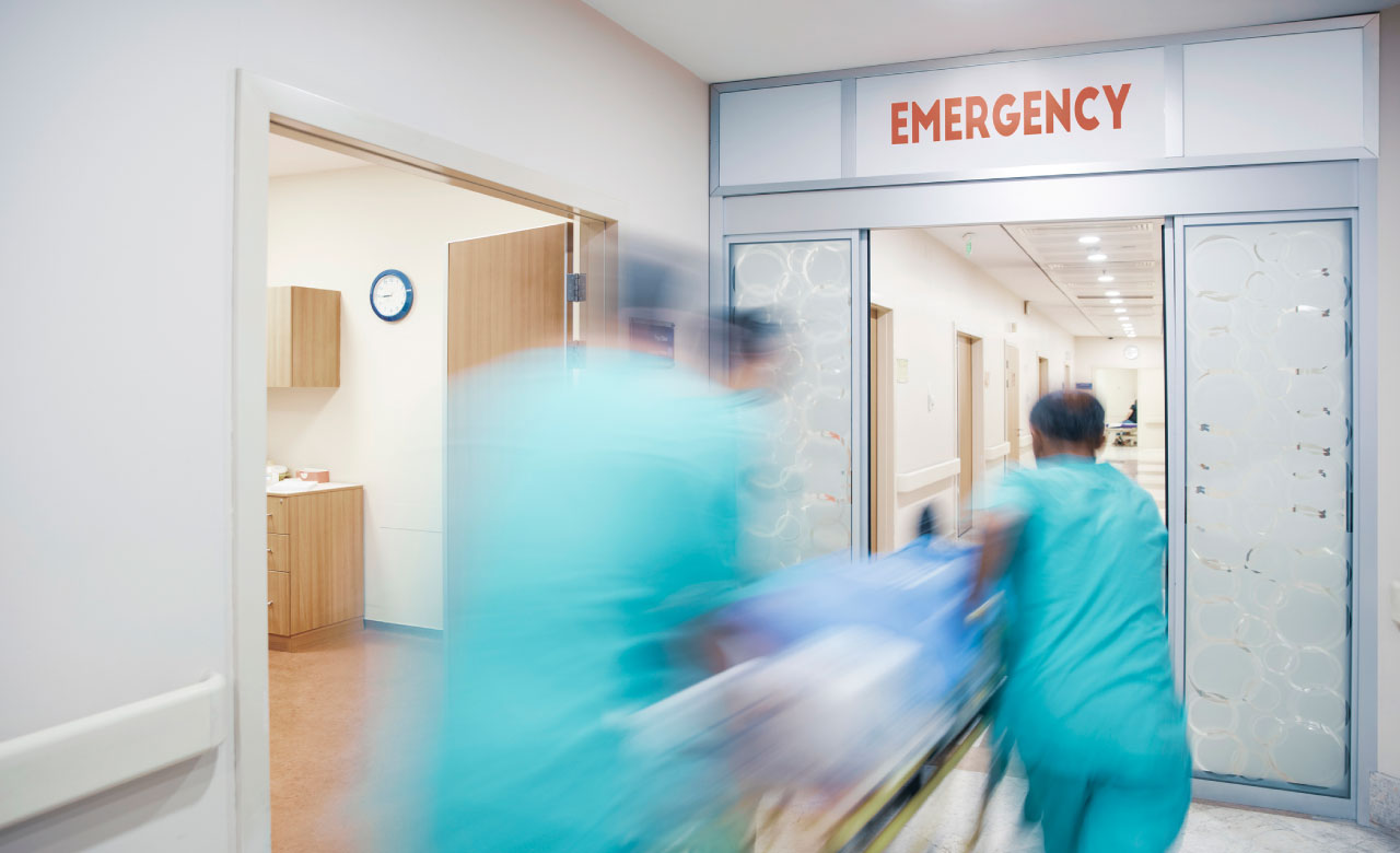Time lapse blurred image of a patient being whisked away to the Emergency Room