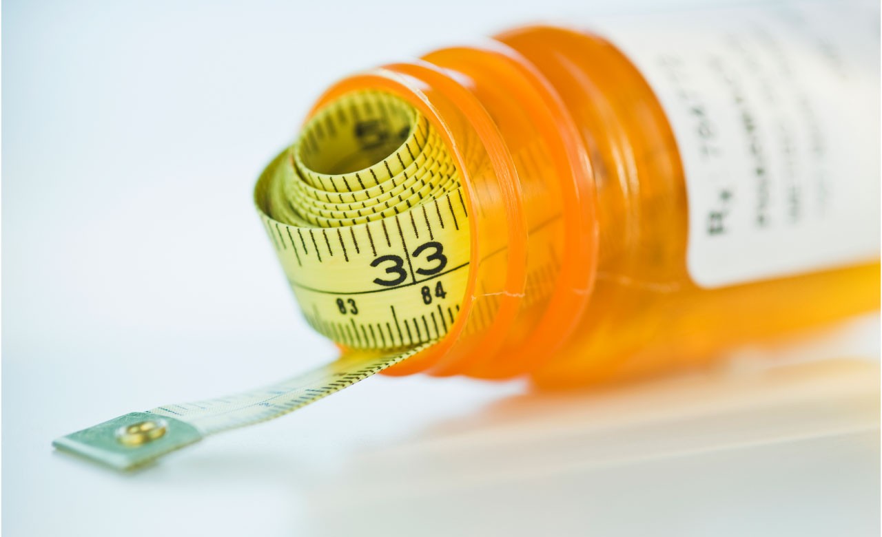 Image of a tape measure in a pill bottle.