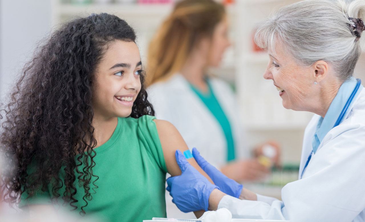 Young patient receiving vaccination from pharmacist